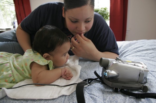 Damaris and Andrea watching Andrea\'s birth video