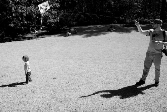 Mark flying a kite. Lili walking about aimlessly.
